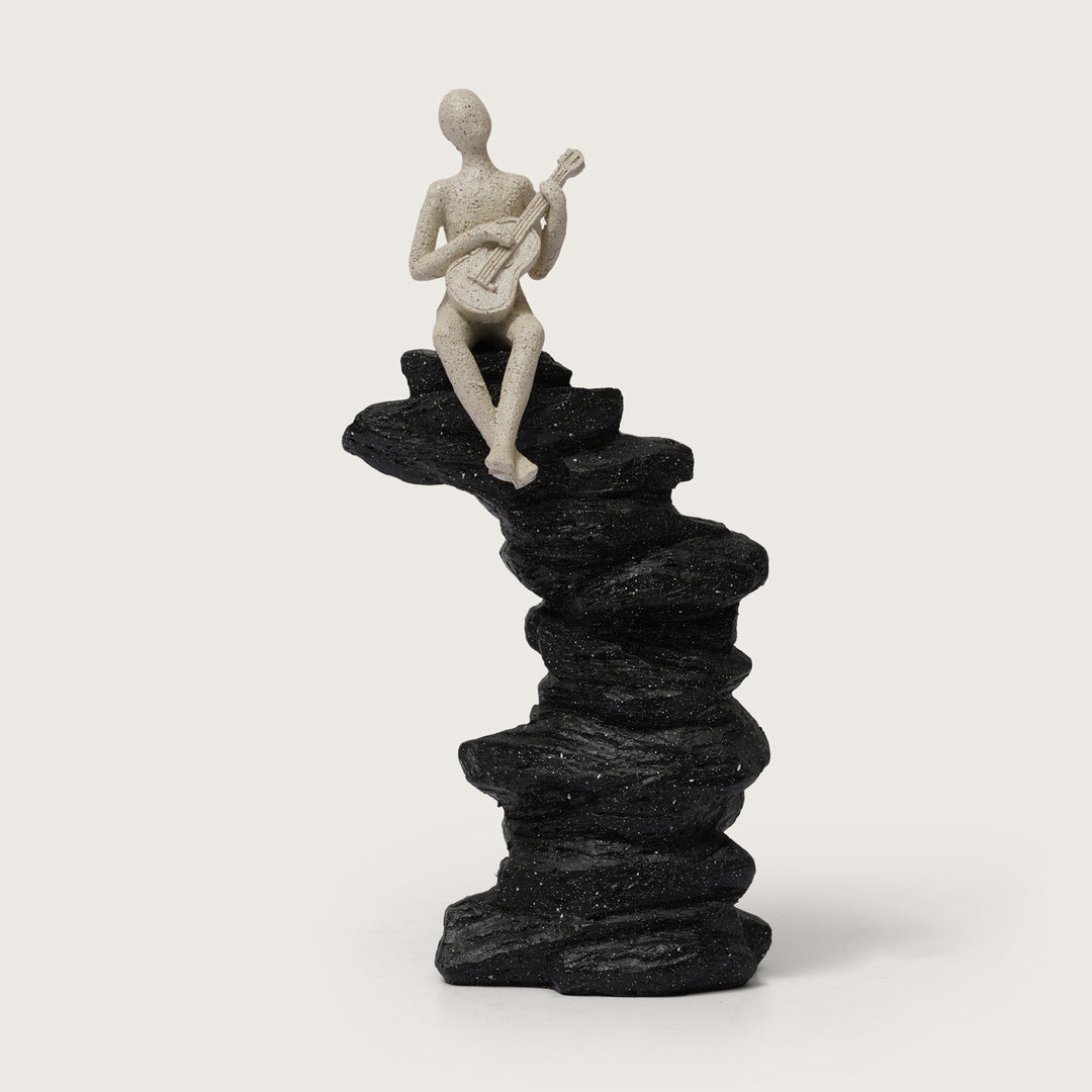 Guitarist Figurine on Stacked Rock Sculpture