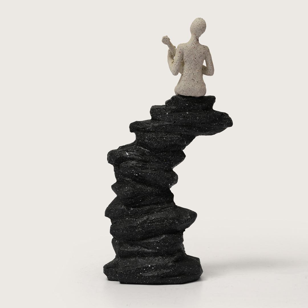 Guitarist Figurine on Stacked Rock Sculpture