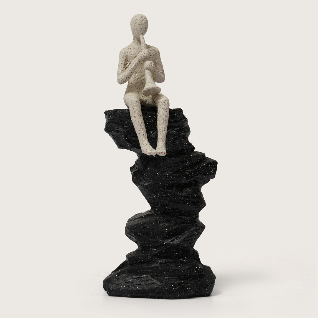 Horn Player Figurine on Stacked Rock Sculpture