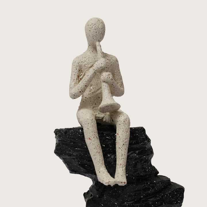Horn Player Figurine on Stacked Rock Sculpture