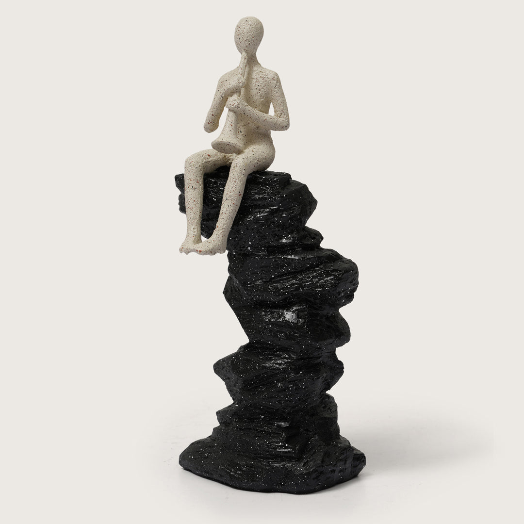 Horn Player Figurine on Stacked Rock Sculpture