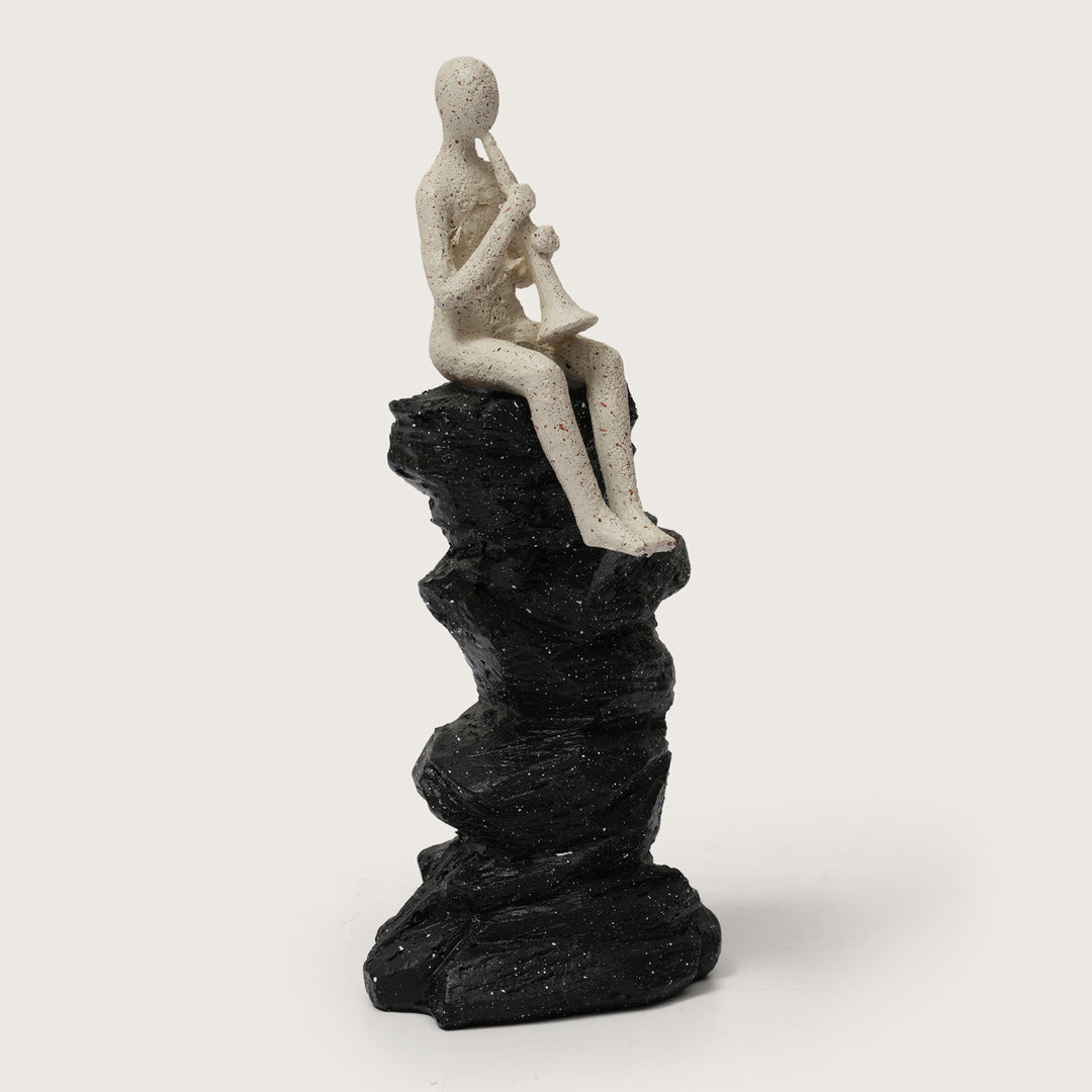 Horn Player Figurine on Stacked Rock Sculpture