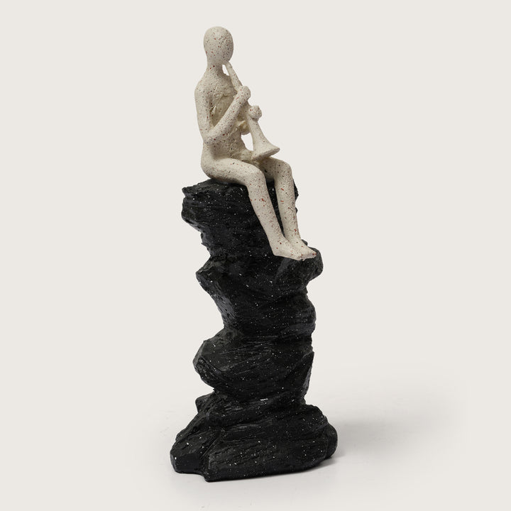 Horn Player Figurine on Stacked Rock Sculpture