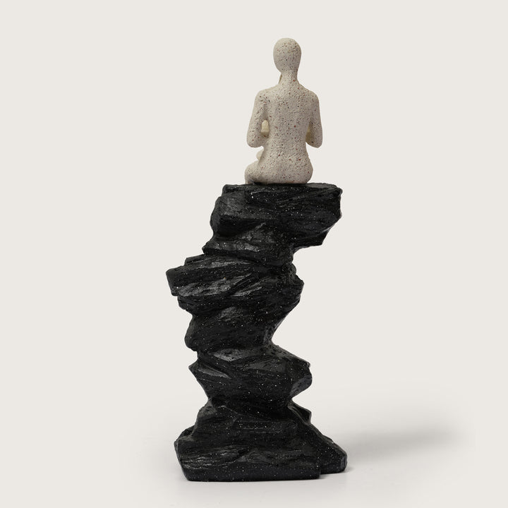 Horn Player Figurine on Stacked Rock Sculpture