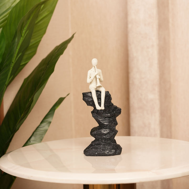 Horn Player Figurine on Stacked Rock Sculpture