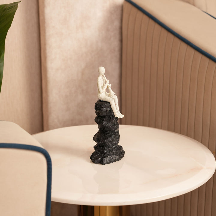 Horn Player Figurine on Stacked Rock Sculpture